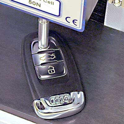 Vehicle key fob button actuation force testing